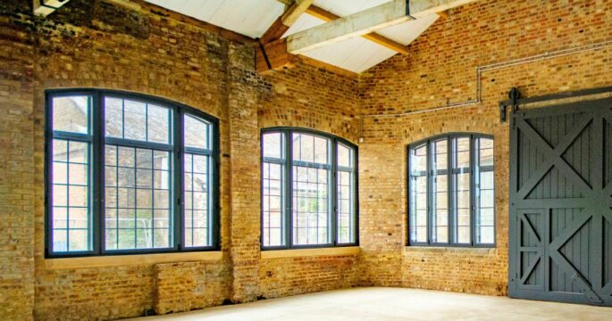 arched windows in a barn fitted with secondary glazing