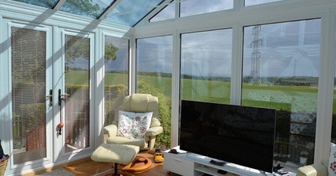 Internal view of gable front conservatory with TV stand and two chairs