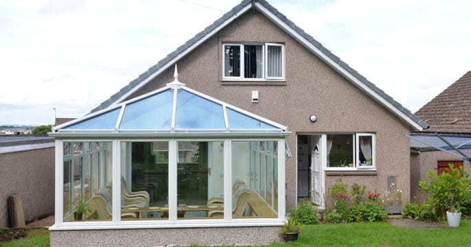 Edwardian shaped white conservatory with blue tinted smartglass roof