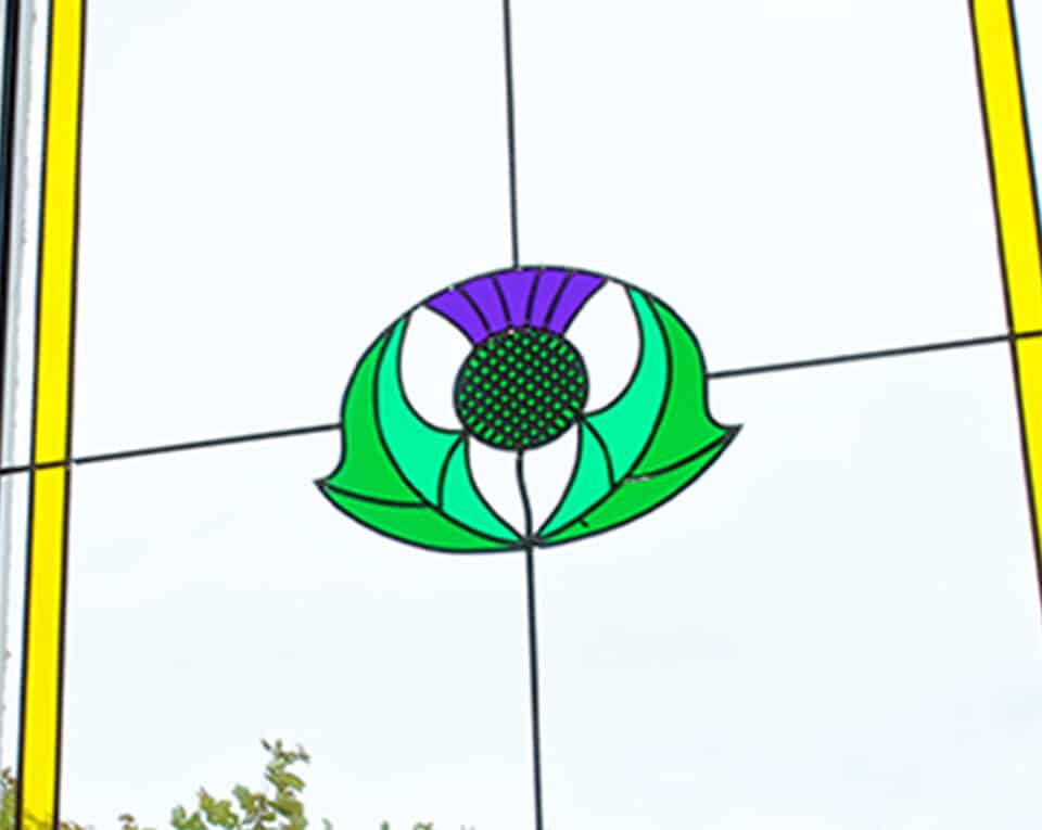 Close up of a Scottish thistle stained glass window design