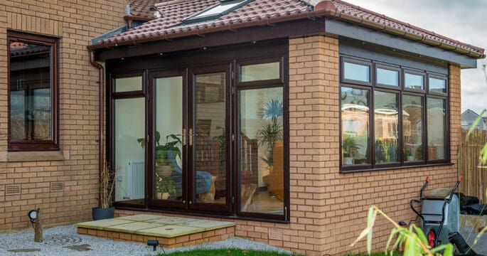 External view of lorimer sunroom with rosewood french doors and casement windows