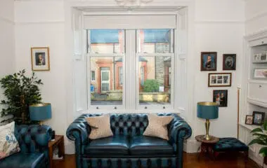 White upvc sliding sash windows in a Victorian property with white wainscot paneling