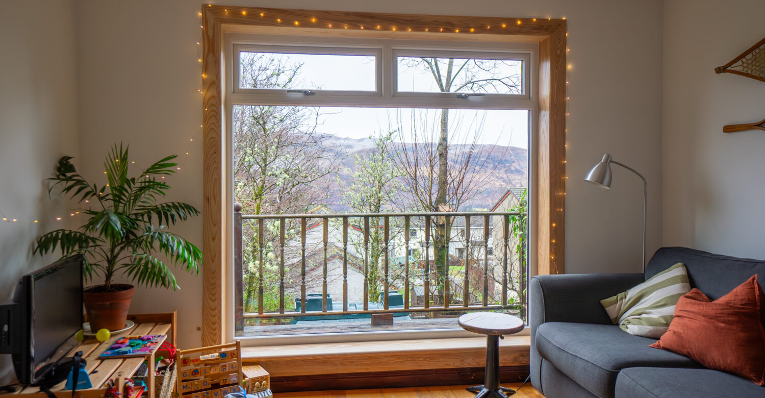 A white uPVC casement window with top hoppers, complete with royal oak timber sills and surrounds at a Fort William Installation.