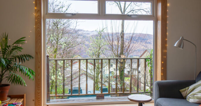 A white uPVC casement window with top hoppers, complete with royal oak timber sills and surrounds at a Fort William Installation.