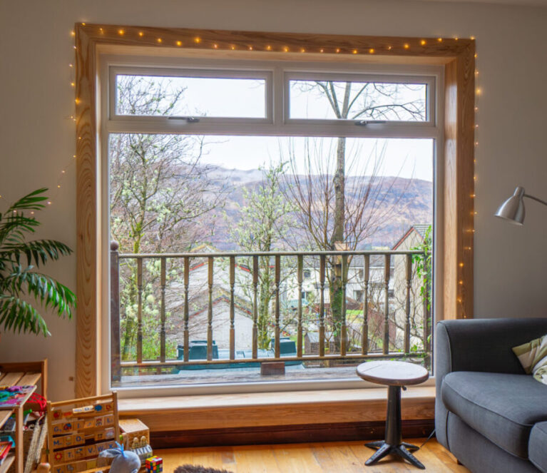 A white uPVC casement window with top hoppers, complete with royal oak timber sills and surrounds at a Fort William Installation.