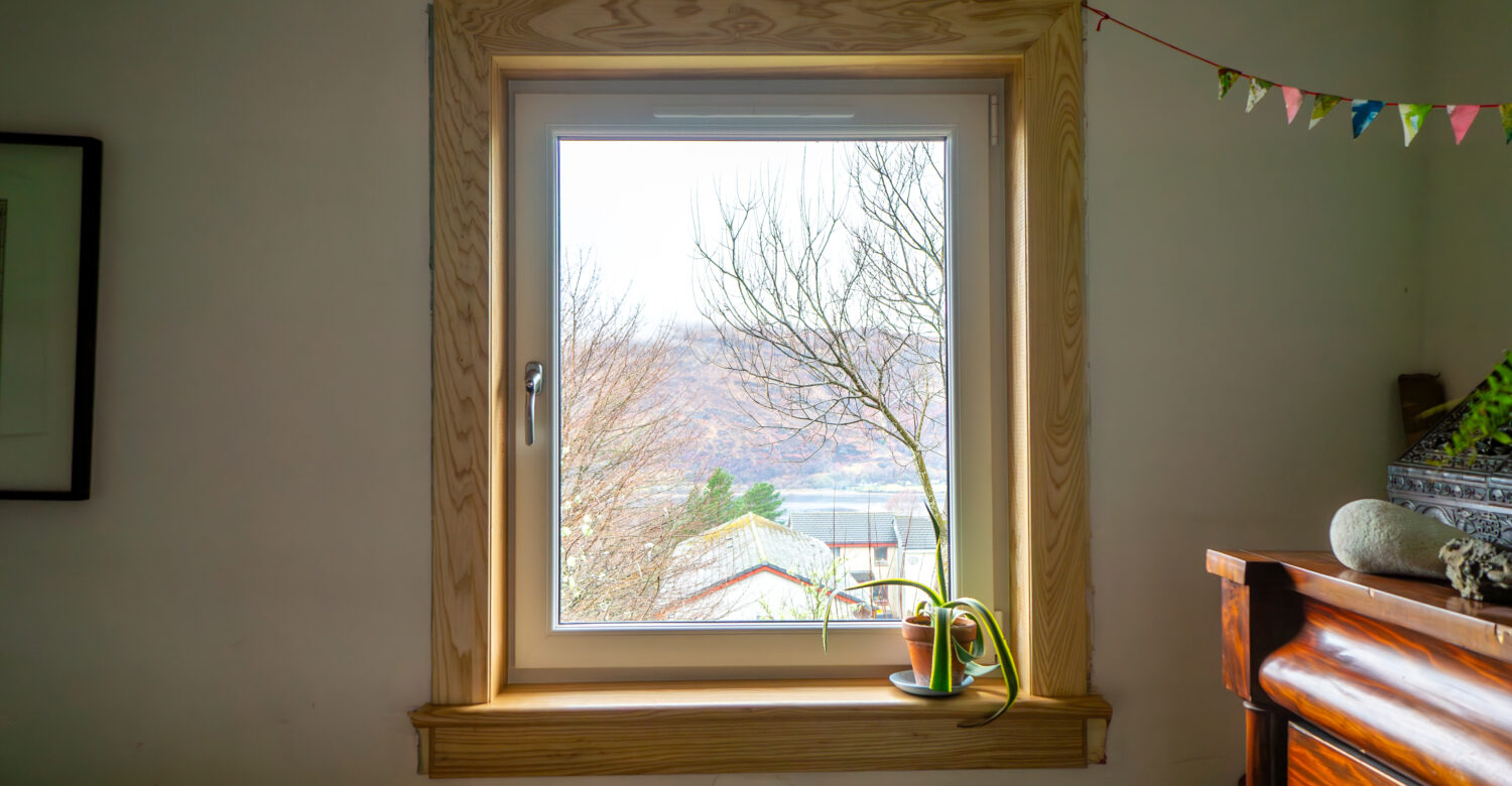 A white uPVC casement window complete with royal oak timber sills and surrounds at a Fort William Installation