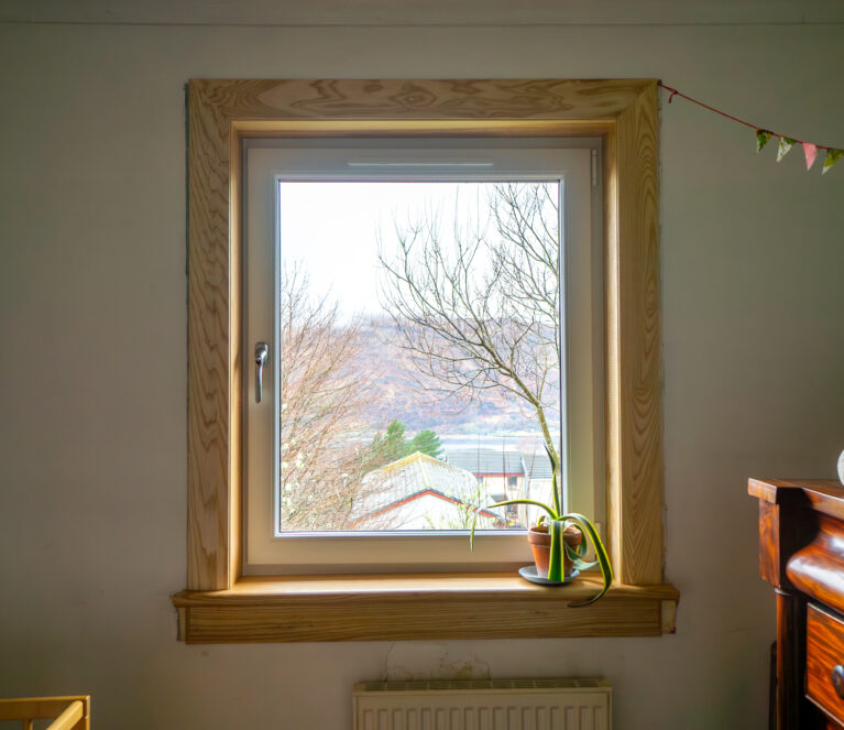 A white uPVC casement window complete with royal oak timber sills and surrounds at a Fort William Installation