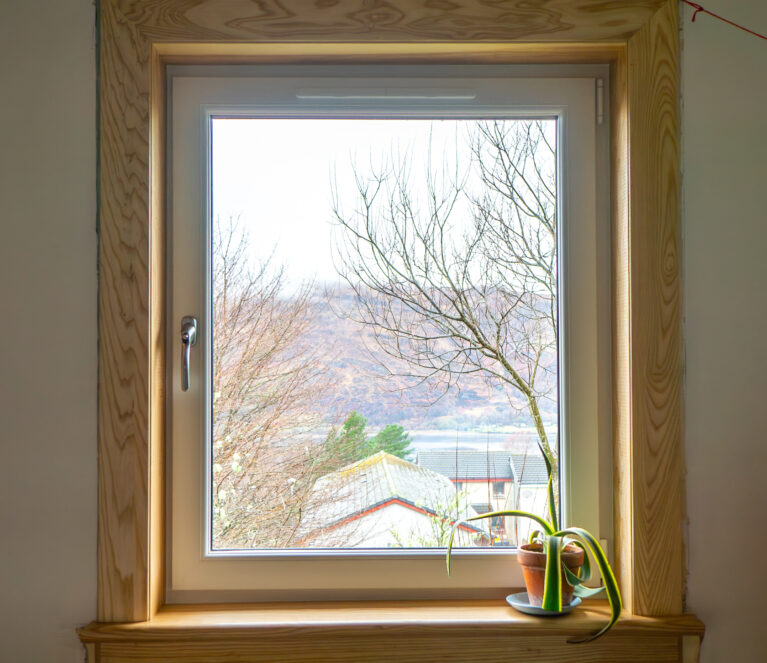 A white uPVC casement window complete with royal oak timber sills and surrounds at a Fort William Installation.