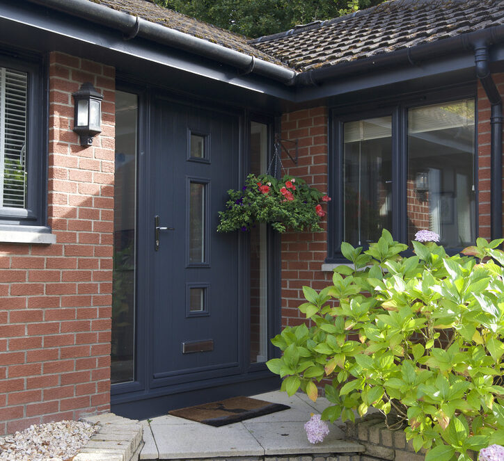 Exterior shot of a front door in an anthracite finish. Complete with two frosted glass side screen