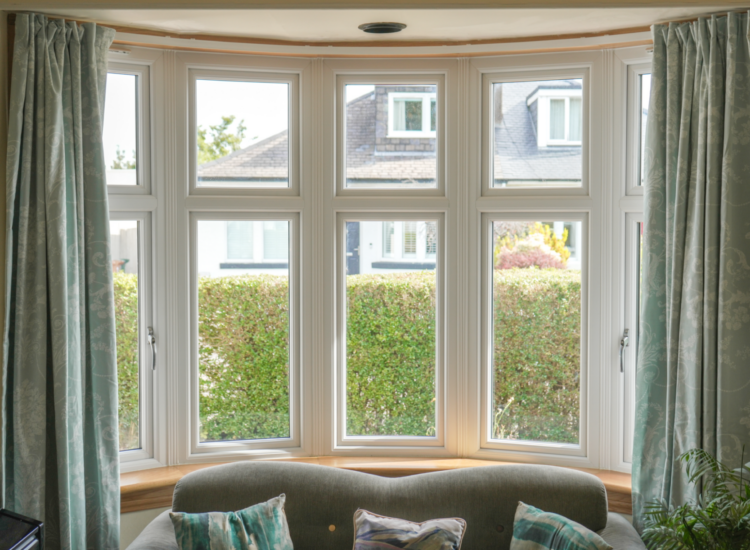 Living room, white uPVC casement windows in bay windows. Edinburgh home.