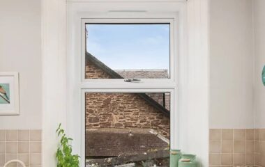 White Lorimer Casement window located abover the sink in the kitchen, with fixed bottom pane and top opener. Complete with internal white sills and surround.