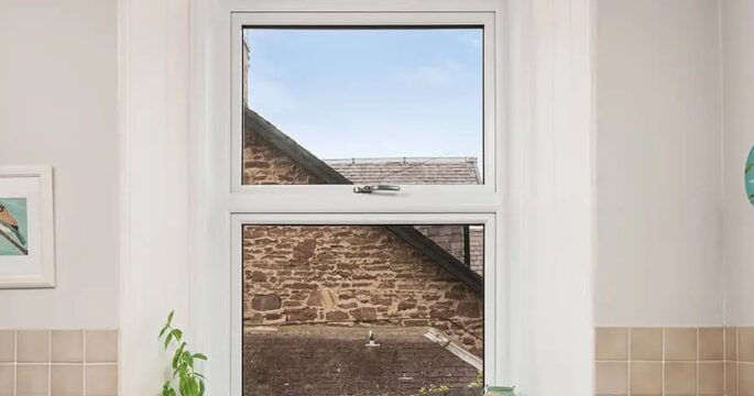 White Lorimer Casement window located abover the sink in the kitchen, with fixed bottom pane and top opener. Complete with internal white sills and surround.